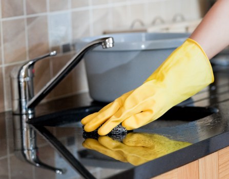 Domestic cleaner working in a Camden apartment living room